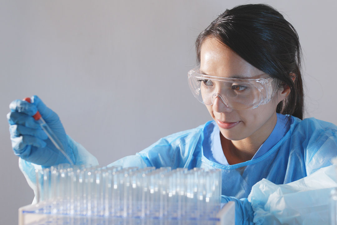 A laboratory assistant in a laboratory with test tubes.
